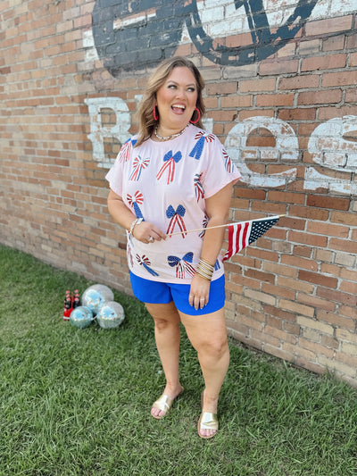 Queen of Sparkles Light Pink Red, White & Blue Scattered Bow Tee